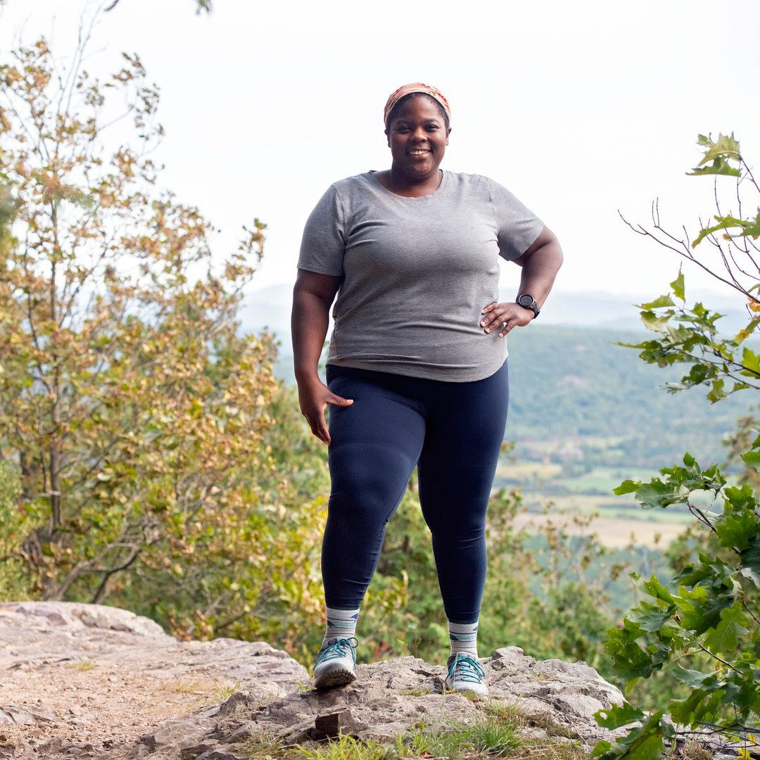 Mirna Valeria wearing darn tough socks and smiling from the trail