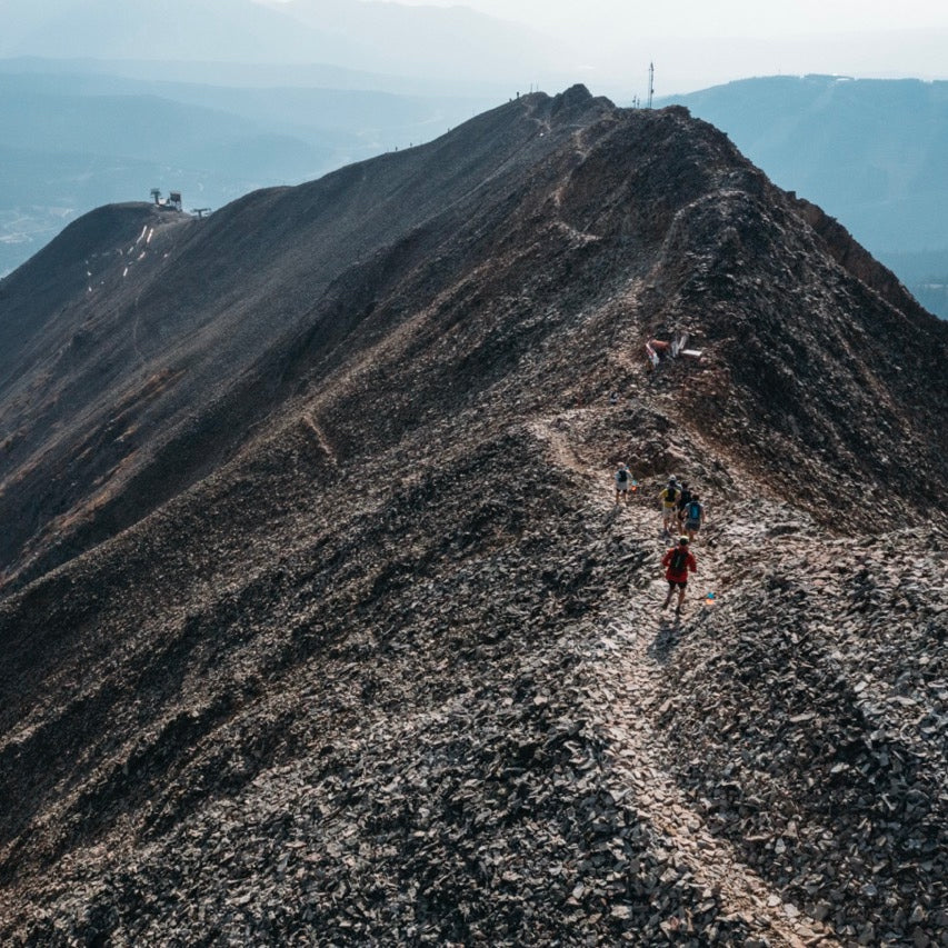 Runners headed along a dramatic ridgeline, part of the Rut race