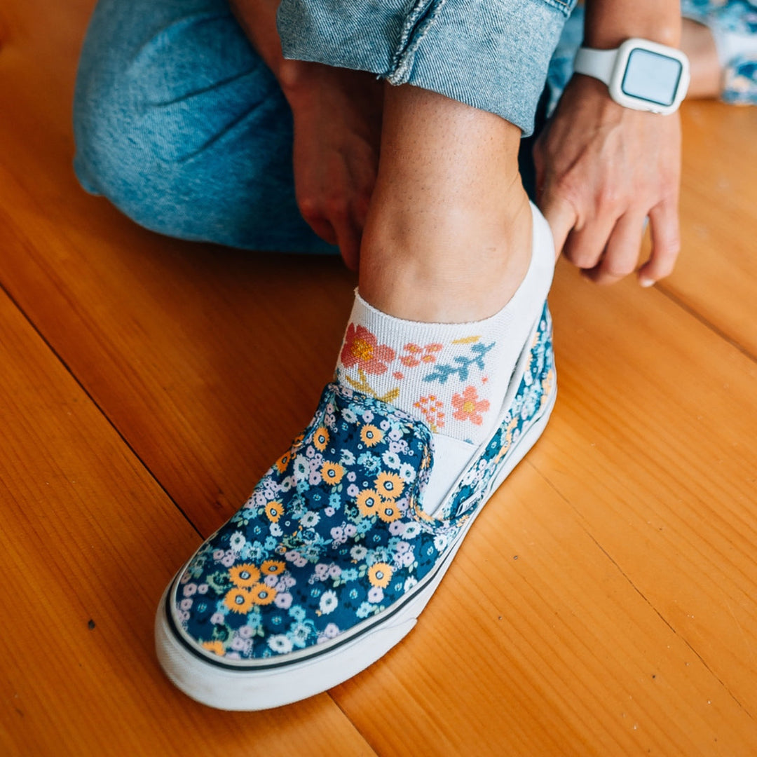 Person putting on slip on shoes over Garden Party no show socks.