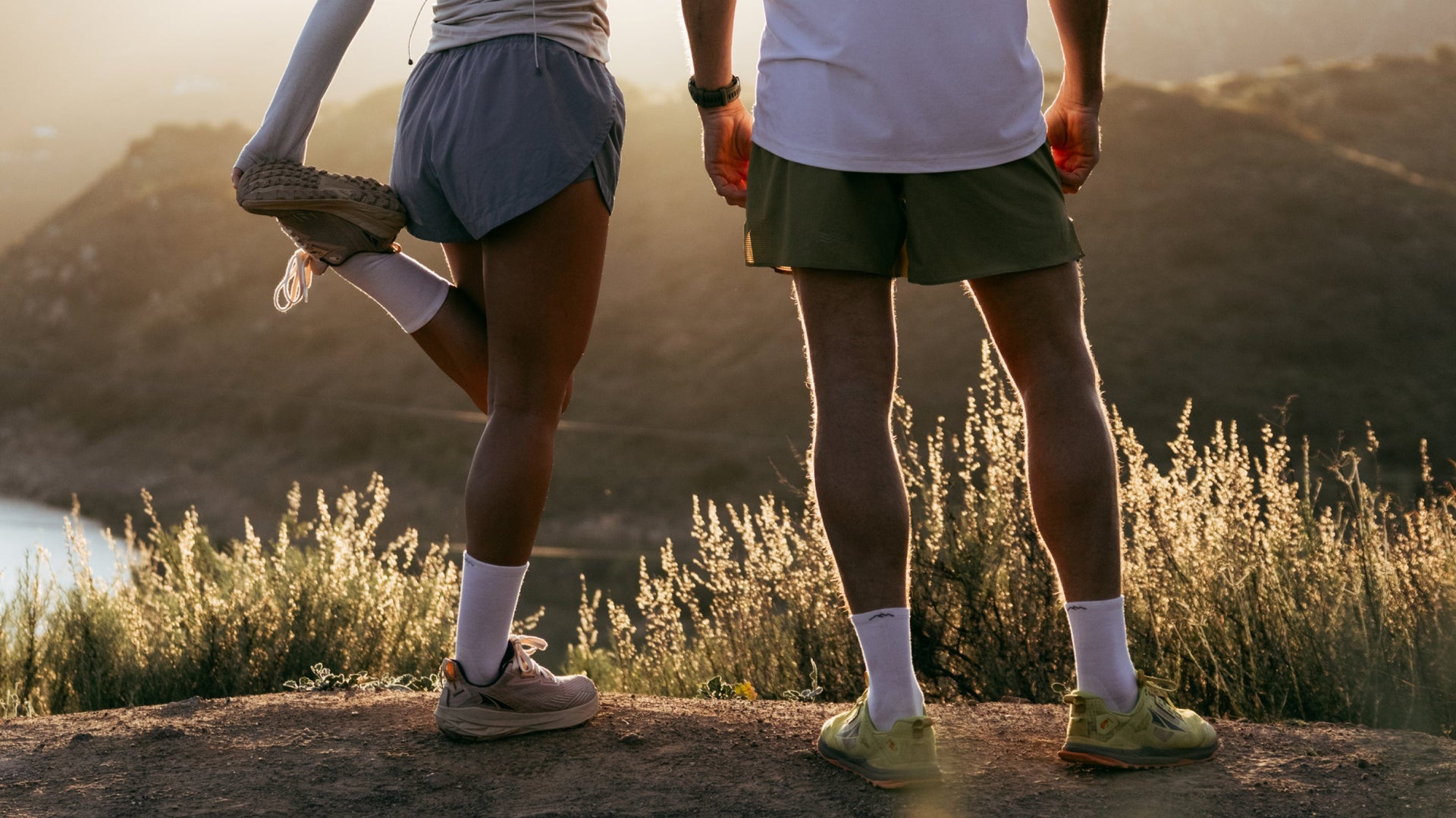 Two Models Stretching in the early morning wearing the white Micro Crew Running socks