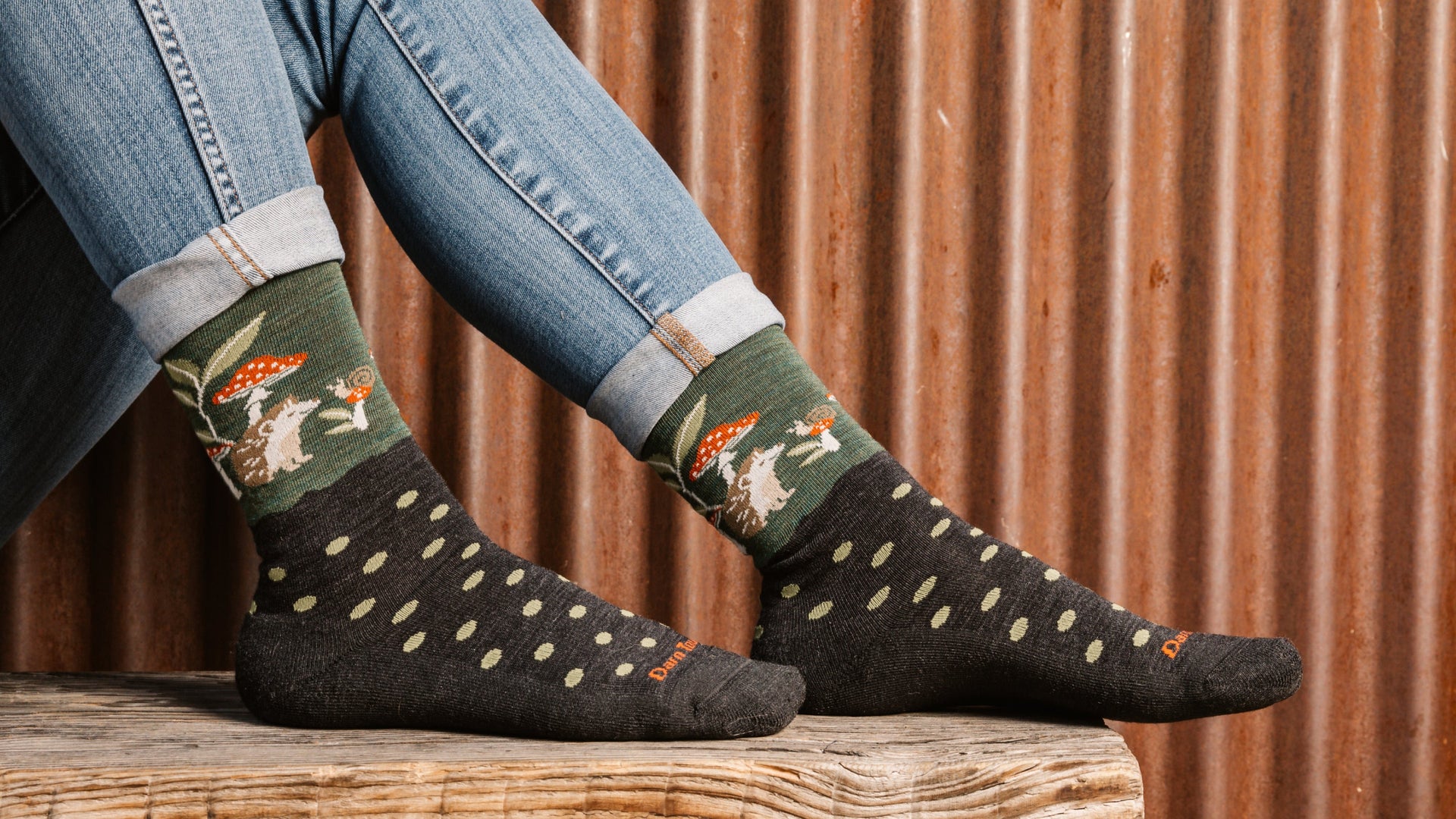 Models feet on bench showing the wild life crew sock in hedgehog green