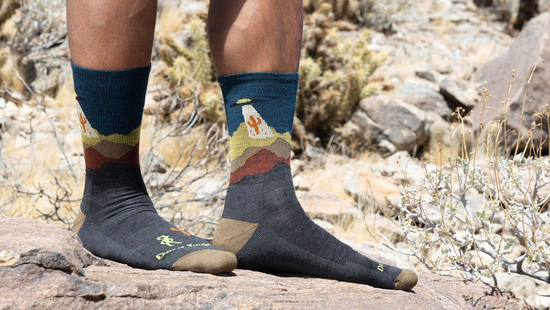 Model Standing on Roocks wearing the Spaced out micro crew hiking sock