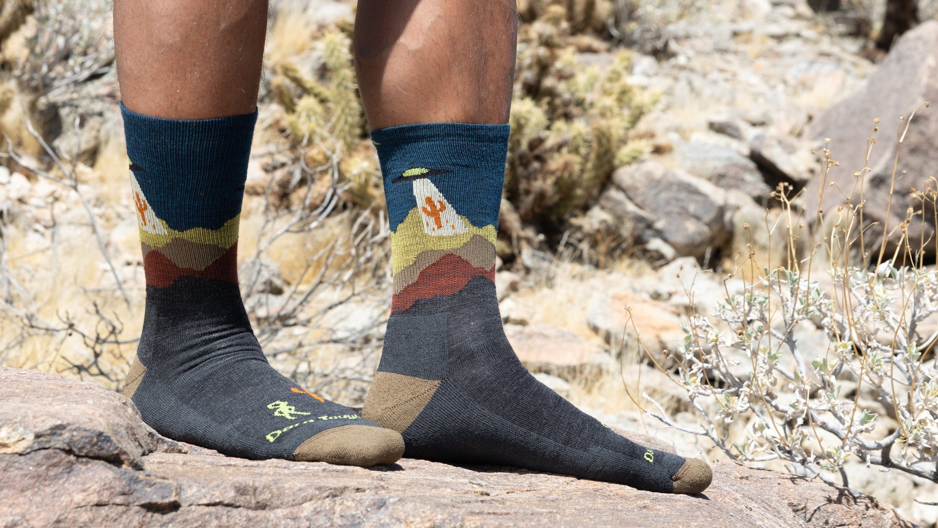 Model Standing on Roocks wearing the Spaced out micro crew hiking sock