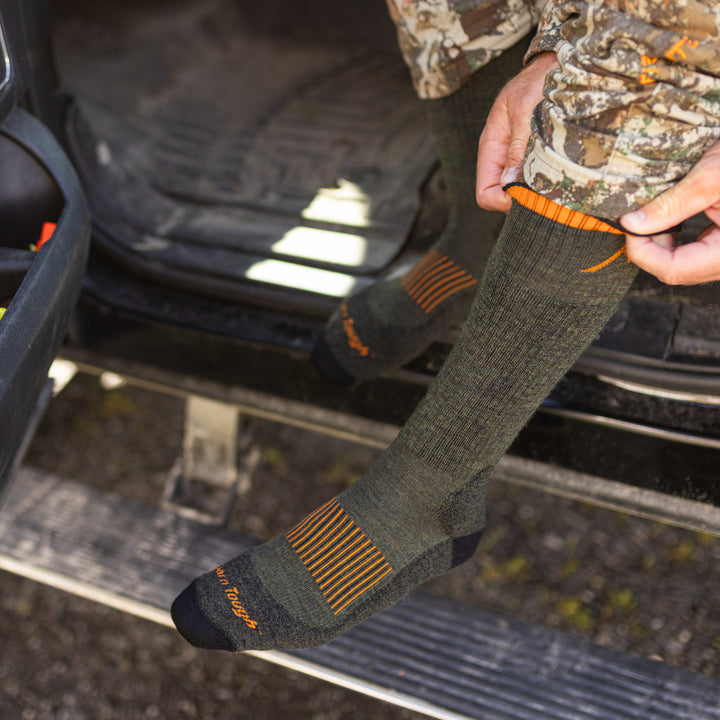 close up of model putting on the 2111 in forest  while sitting in car