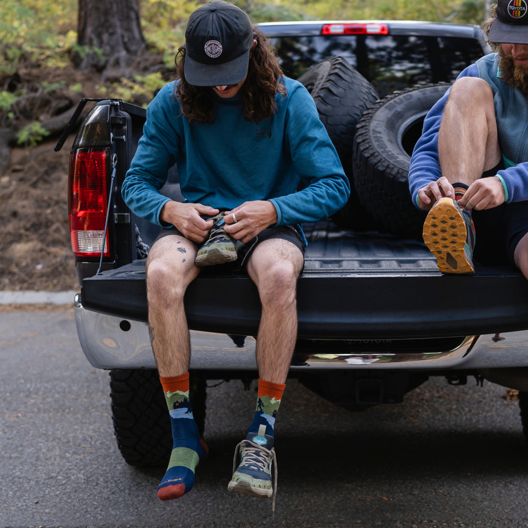 model sitting on tailgate putting on shoes while wearing the 5014 Close Encounter in Eclipse