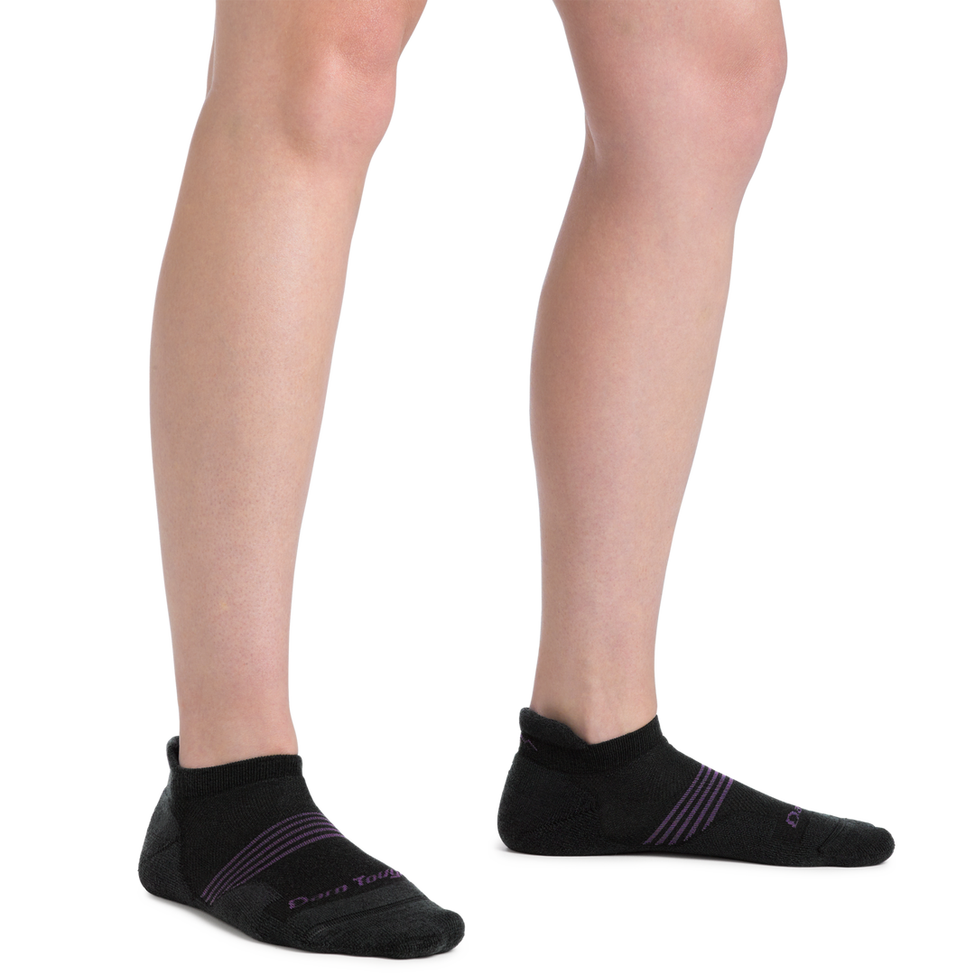 Close up shot of model wearing the women's element no show tab running sock in black with no shoes on