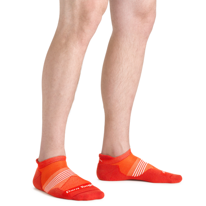Close up shot of model wearing the men's element no show tab running sock in tiger color with no shoes on