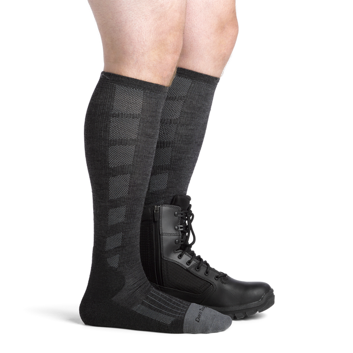 Model wearing the men's Stanly K OTC work socks in Gravel with a black boot on his left foot