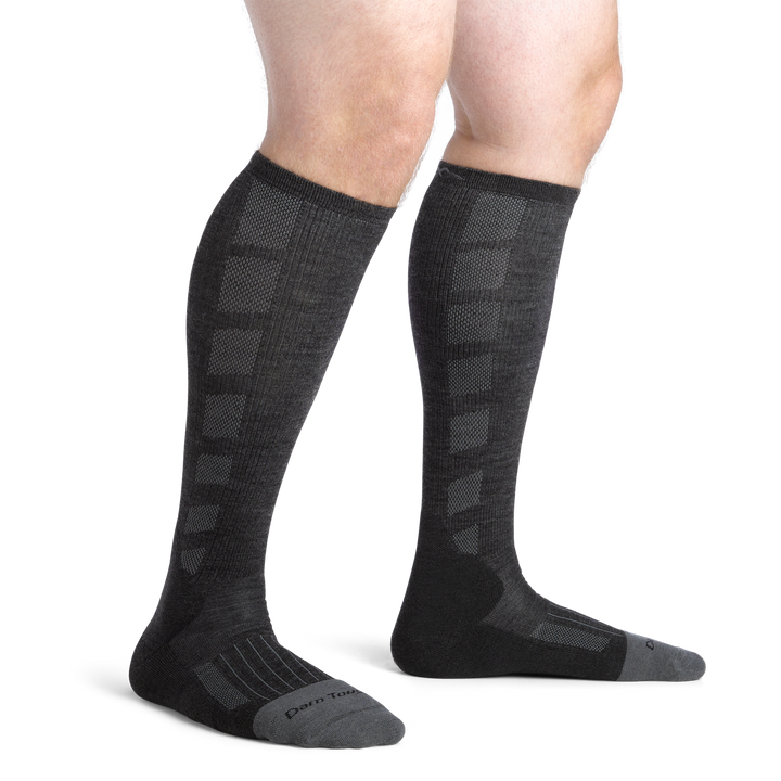 Close up shot of model wearing the men's Stanly K OTC work socks in gravel with no shoes on