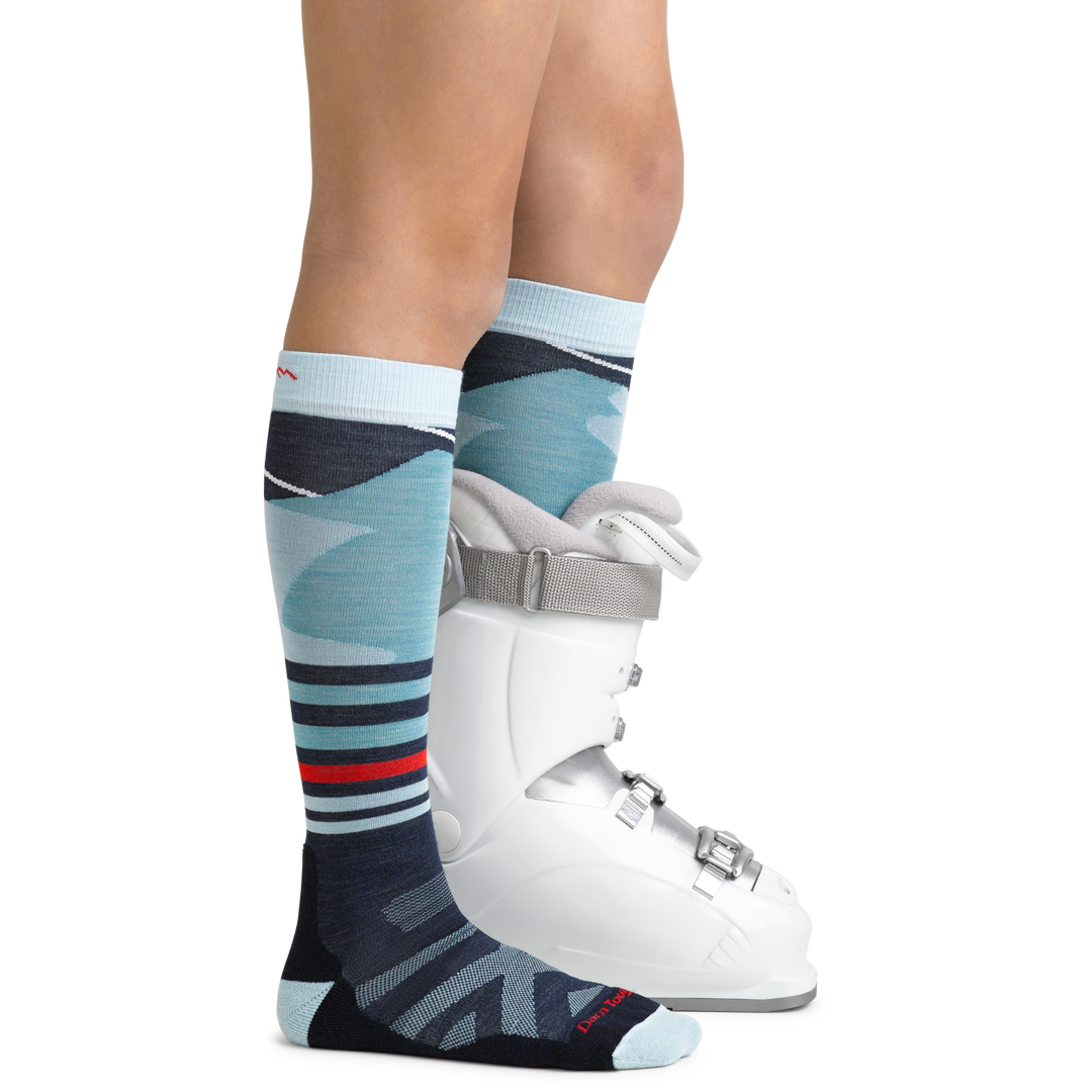 Skipper Kids' Snowboard and Ski Sock in Glacier Blue with feet in ski boot