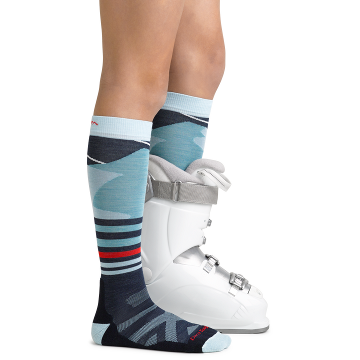 Skipper Kids' Snowboard and Ski Sock in Glacier Blue with feet in ski boot