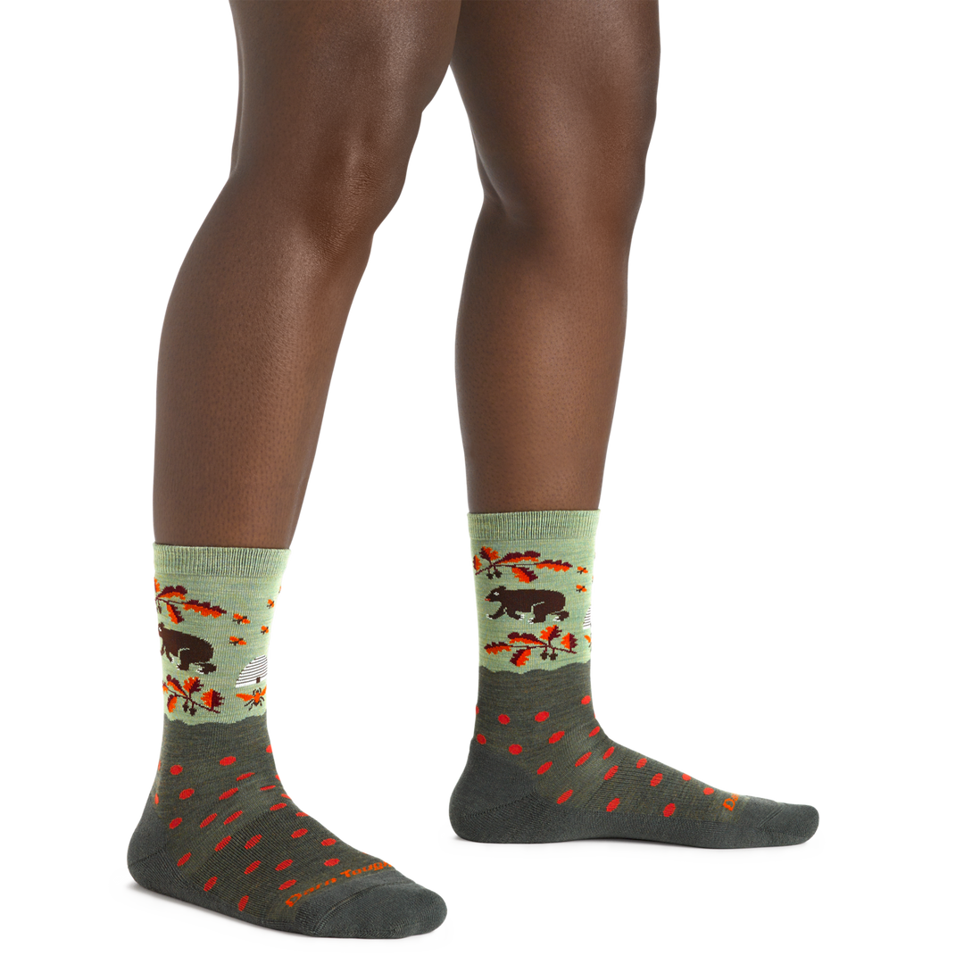 Close up shot of model wearing the women's wild life crew lifestyle socks in Forest with no shoes on